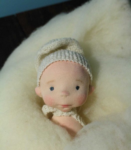 Doll's head in sculpted wool