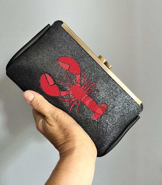Embroidered glitter leather clutch bag